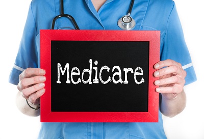 Woman holding Medicare sign